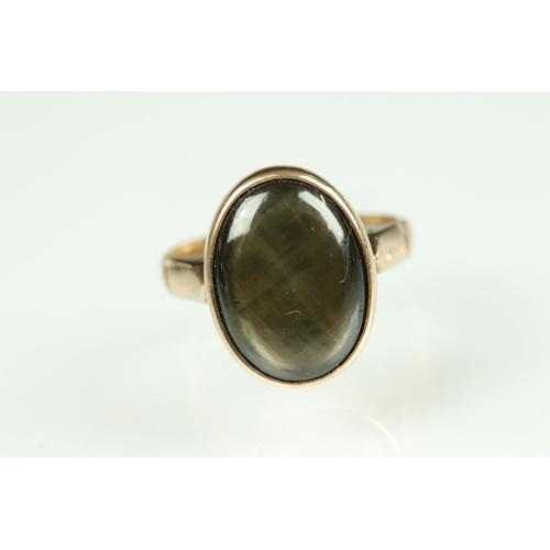 34 - Cats eye smoky quartz 14ct yellow ring, the oval cabochon measuring approx 13.5 x 10mm, rubover set,... 