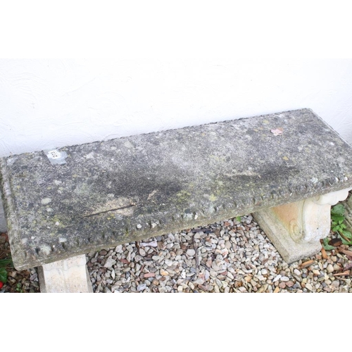 273 - Reconstituted stone garden bench / seat of rectangular form, raised on two feet scrolled feet. (Meas... 