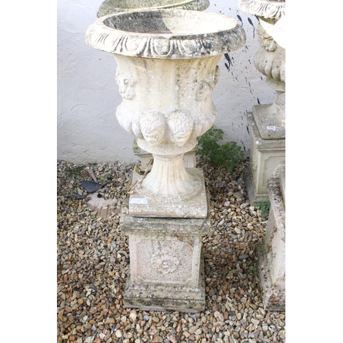 275 - Pair of reconstituted stone garden urns of campana form, with relief facial mask decoration and gadr... 