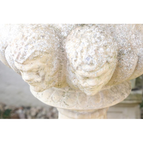 275 - Pair of reconstituted stone garden urns of campana form, with relief facial mask decoration and gadr... 
