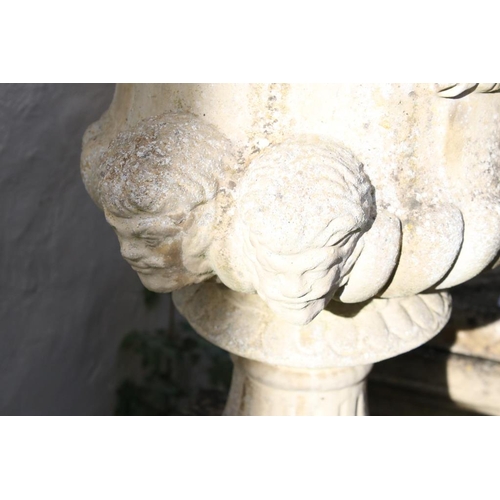 277 - Pair of reconstituted stone garden urns of campana form, with relief facial mask decoration and gadr... 