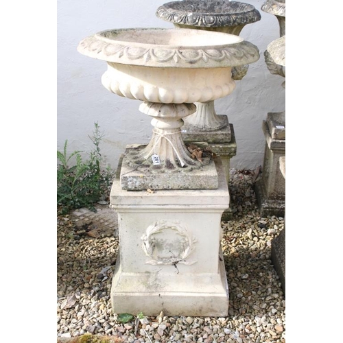 281 - Pair of reconstituted stone garden urns, the bowls of shallow form, with ovolu-moulded rims and gadr... 