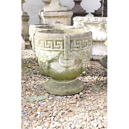 285 - Set of three reconstituted stone planters with Greek key and grape decoration, raised on circular fe... 