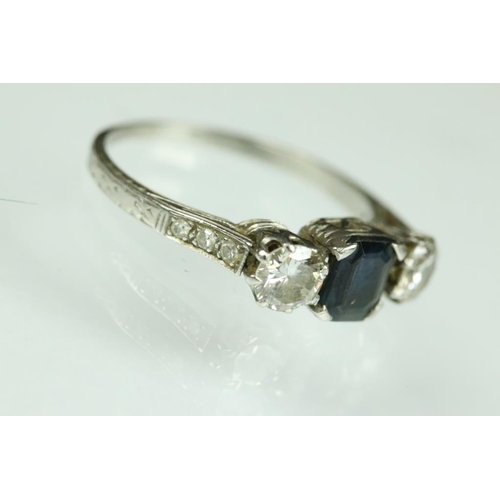 21A - Diamond and sapphire platinum three stone ring, the central truncated rectangular cut sapphire measu... 