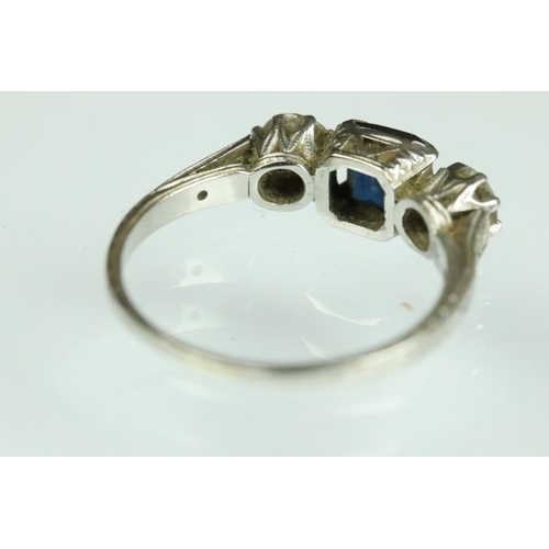 21A - Diamond and sapphire platinum three stone ring, the central truncated rectangular cut sapphire measu... 