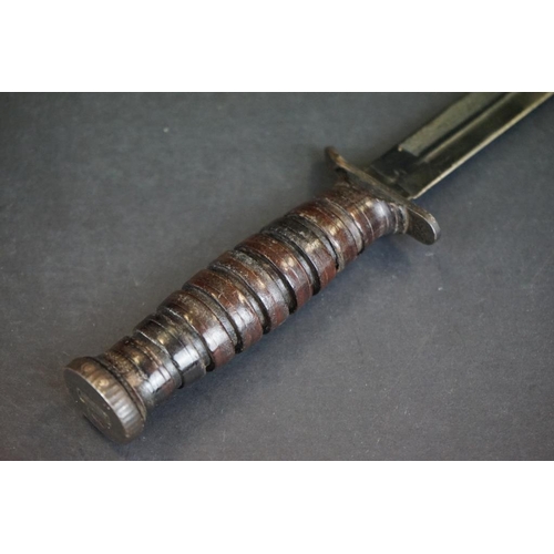 A United States Marine Corps M3 fighting knife with M8 scabbard.