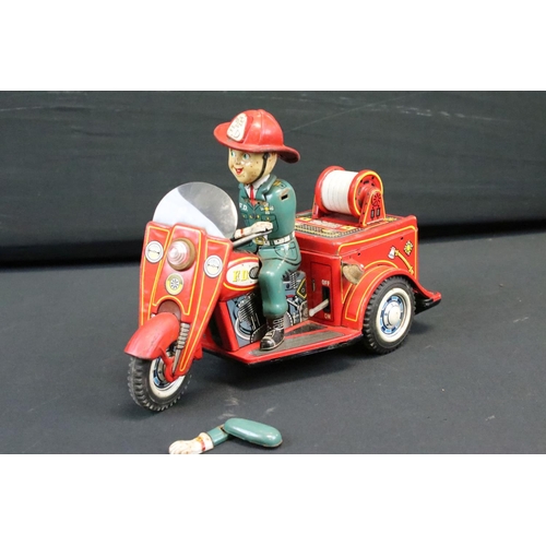 1136 - Four play worn mid 20th C battery-operated tinplate models to include 2 x T.N Nomura of Japan (fire ... 