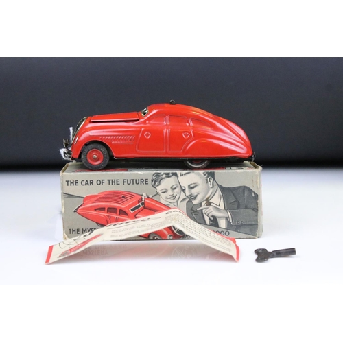 1484 - Boxed Schuco Command Car AD2000 clockwork model in red, with key and paperwork, plus a boxed Schuco ... 