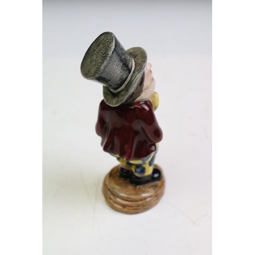 57 - Four Alice In Wonderland porcelain figures to include Royal Worcester Alice candle snuffer, modelled... 