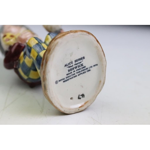 57 - Four Alice In Wonderland porcelain figures to include Royal Worcester Alice candle snuffer, modelled... 