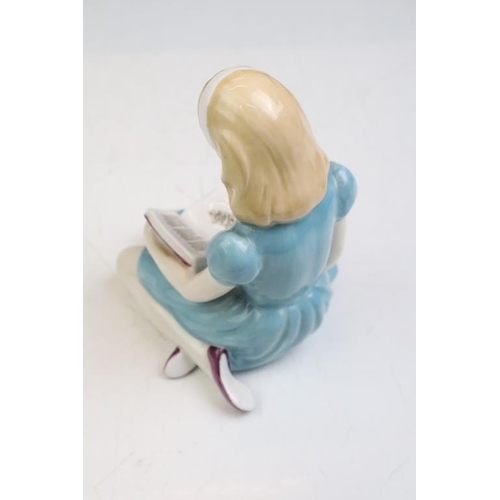 57 - Four Alice In Wonderland porcelain figures to include Royal Worcester Alice candle snuffer, modelled... 