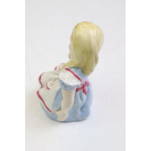 57 - Four Alice In Wonderland porcelain figures to include Royal Worcester Alice candle snuffer, modelled... 