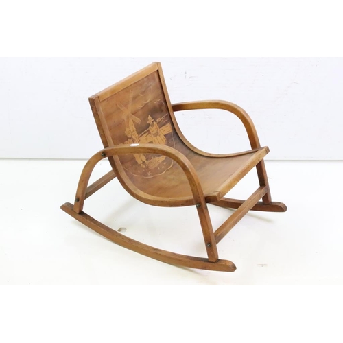650 - Mid century Bentwood Child’s Rocking Chair decorated with a Dutch Boy and Girl, 36cm wide x 44cm hig... 