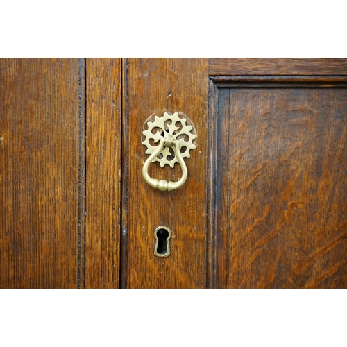 652 - Early 19th century Oak House-keeper’s Cupboard, the upper section with three panel doors opening to ... 