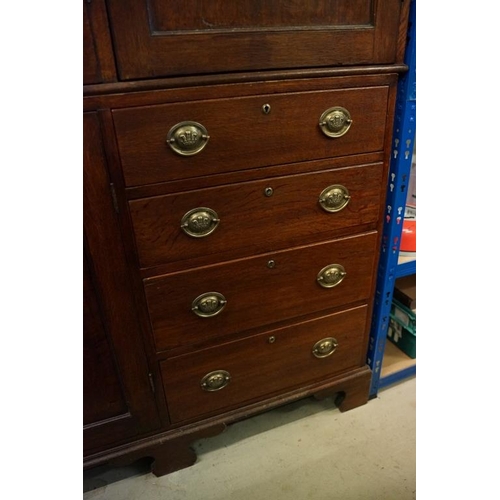 652 - Early 19th century Oak House-keeper’s Cupboard, the upper section with three panel doors opening to ... 