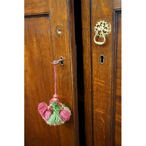 652 - Early 19th century Oak House-keeper’s Cupboard, the upper section with three panel doors opening to ... 