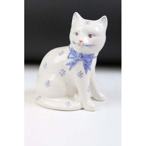 38 - Group of four ceramic animals to include a Goebel cat, a Poole pottery penguin, Rye pottery cat and ... 