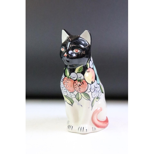 38 - Group of four ceramic animals to include a Goebel cat, a Poole pottery penguin, Rye pottery cat and ... 