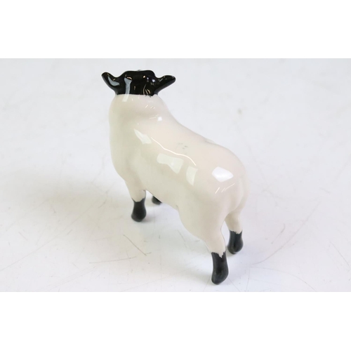 61 - Three Beswick ceramic sheep figurines to include a ewe, and two horned sheep. All with stamped marks... 