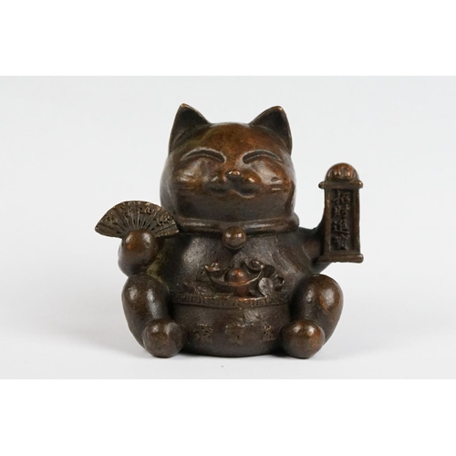 217 - An ornamental Japanese bronze 招き猫 / maneki-neko (waving / beckoning) lucky cat talisman.