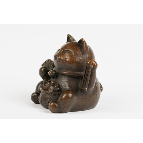 217 - An ornamental Japanese bronze 招き猫 / maneki-neko (waving / beckoning) lucky cat talisman.