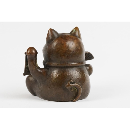 217 - An ornamental Japanese bronze 招き猫 / maneki-neko (waving / beckoning) lucky cat talisman.