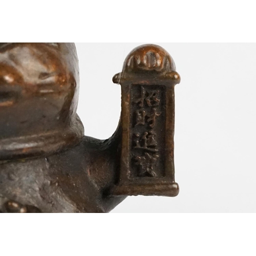 217 - An ornamental Japanese bronze 招き猫 / maneki-neko (waving / beckoning) lucky cat talisman.