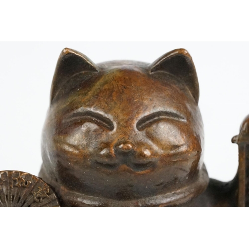 217 - An ornamental Japanese bronze 招き猫 / maneki-neko (waving / beckoning) lucky cat talisman.