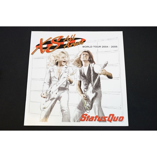 945 - Vinyl & Memorabilia - 4 Status Quo LPs and 4 Status Quo tour programmes from the 1990s / 2000s.