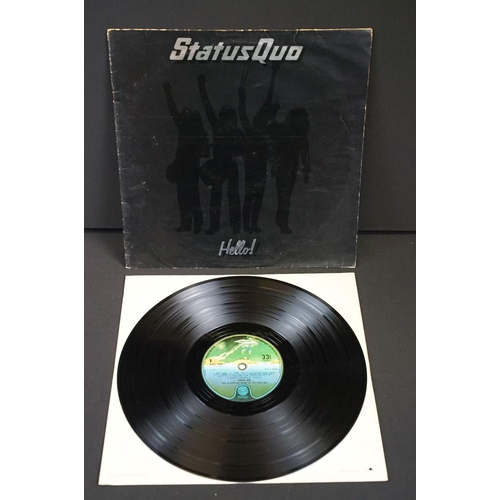 945 - Vinyl & Memorabilia - 4 Status Quo LPs and 4 Status Quo tour programmes from the 1990s / 2000s.