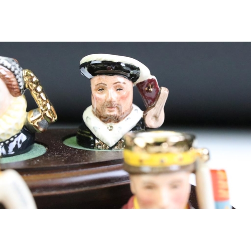 97 - Set of Six Royal Doulton 'Kings & Queens of the Realm' tiny character jugs on wooden display stand (... 