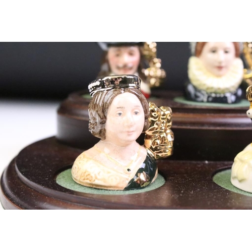 97 - Set of Six Royal Doulton 'Kings & Queens of the Realm' tiny character jugs on wooden display stand (... 