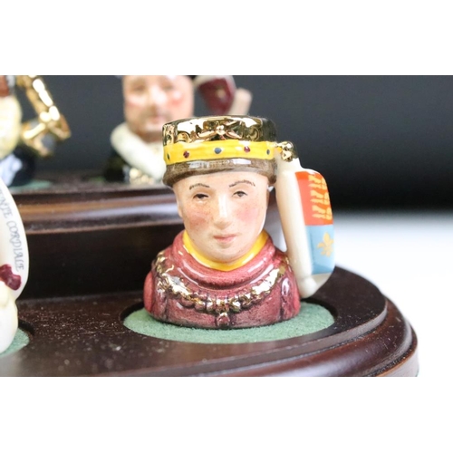 97 - Set of Six Royal Doulton 'Kings & Queens of the Realm' tiny character jugs on wooden display stand (... 