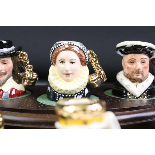 97 - Set of Six Royal Doulton 'Kings & Queens of the Realm' tiny character jugs on wooden display stand (... 