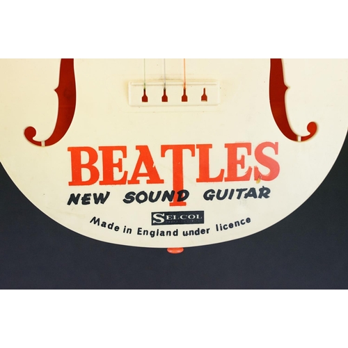 926 - Memorabilia - A Selco Beatles guitar.  Missing one tuning peg