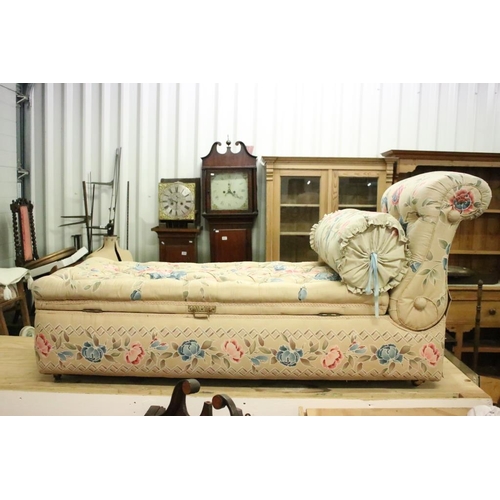 641 - Early 20th century Ottoman Daybed upholstered in cream floral fabric with bolster cushion, raised on... 