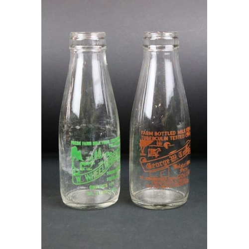 119 - Set of eight vintage glass milk bottles complete with advertising to the sides.