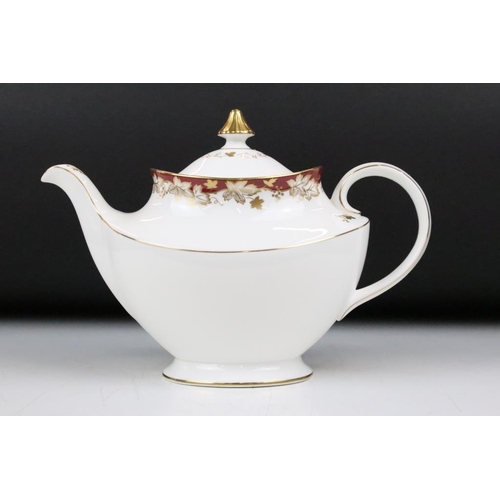 127 - Royal Doulton Winthrop tea service having burgundy and gilt detailing. The lot to include teapot, 12... 