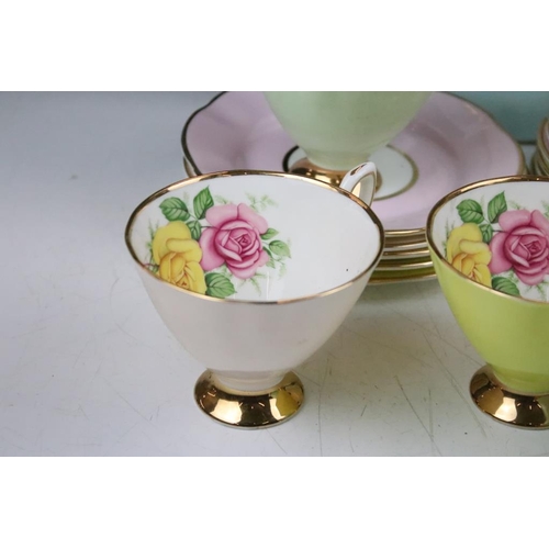 144 - Set of six Cavour Ware trios, each with printed roses to the inside of the cups and gilt rims. All m... 