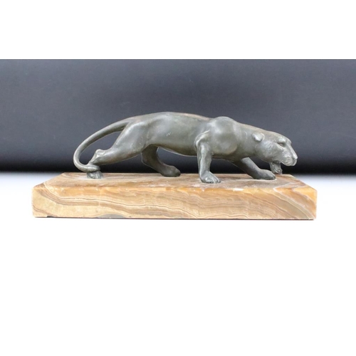 181 - 20th Century cast metal figurine depicting a prowling panther mounted to a banded stone base. Measur... 