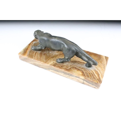 181 - 20th Century cast metal figurine depicting a prowling panther mounted to a banded stone base. Measur... 