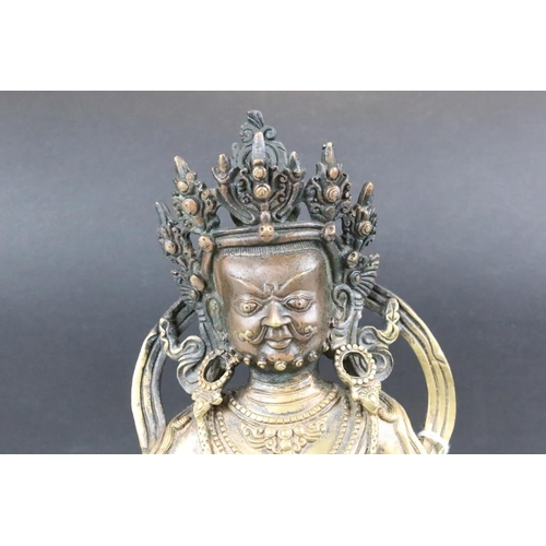 183 - Cast bronze Tibetan Buddha modelled in a seated position on a lotus base with moulded details and a ... 