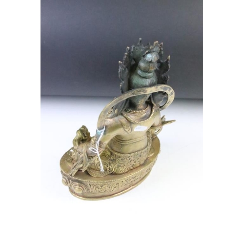 183 - Cast bronze Tibetan Buddha modelled in a seated position on a lotus base with moulded details and a ... 