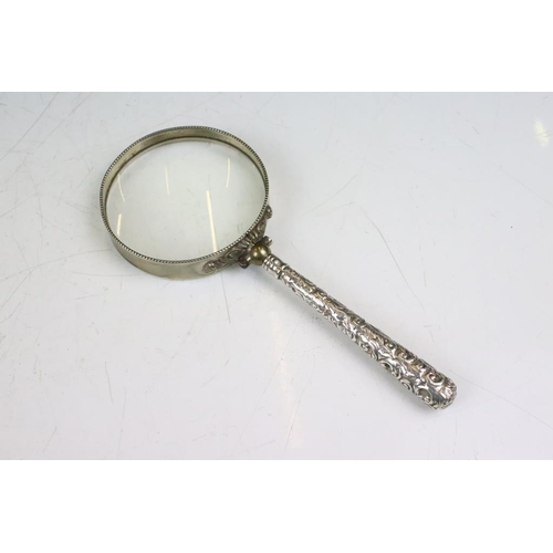 188A - Late 19th / early 20th century magnifying glass, the white metal handle with scrolling Acanthus leaf... 