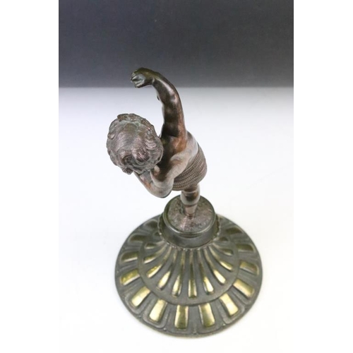 189 - Antique cast bronze putti figurine depicting a classical putti with symbols raised on a fluted cast ... 