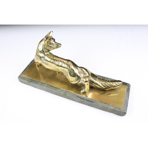 198 - Cast bronze figurine in the form of a prowling fox raised on stone base. Measures 26cm wide.