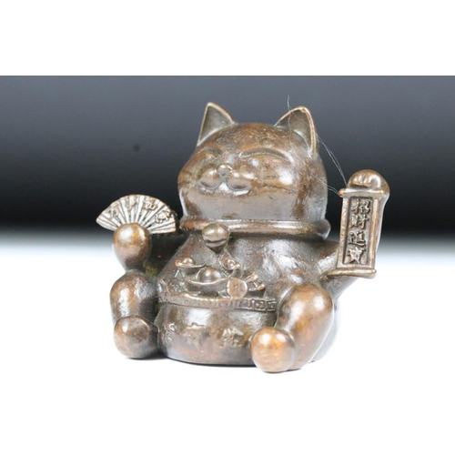 217 - An ornamental Japanese bronze 招き猫 / maneki-neko (waving / beckoning) lucky cat talisman.