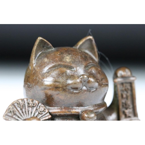 217 - An ornamental Japanese bronze 招き猫 / maneki-neko (waving / beckoning) lucky cat talisman.