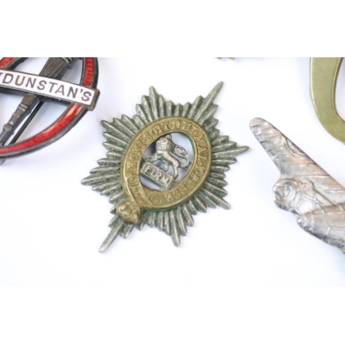 229 - A small collection of military badges to include enamel examples