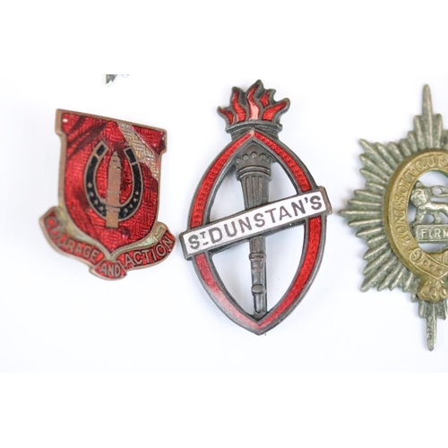 229 - A small collection of military badges to include enamel examples